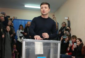 Volodymyr Zelensky throws a ballot in a ballot box
