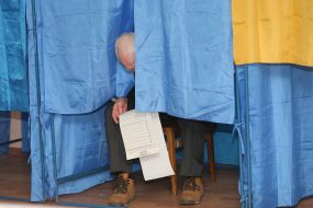 A man in a booth for voting