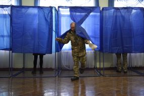 A serviceman goes out of the polling booth