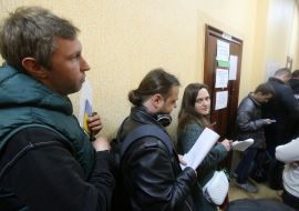 People stand in line to change voting places