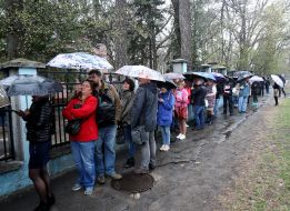 People stand in line to change voting places