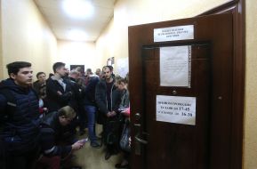 People stand in line to change voting places