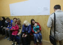 People stand in line to change voting places