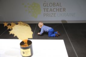 The little boy is playing on the floor