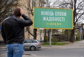 Billboard with the words "The end of the era of greed"