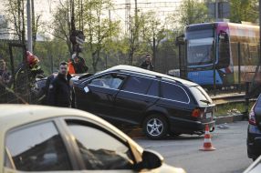 Rescuers remove car from light rail fencing