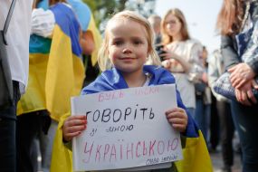 The girl holds a poster