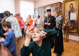 The boy is considering an Easter egg