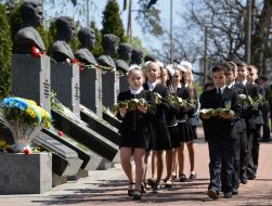 Laying flowers on the alley with busts of Heroes of Chernobyl