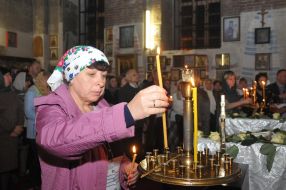 A woman puts a candle
