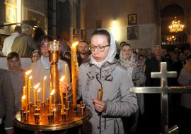A woman puts a candle