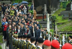 Laying flowers at the graves of heroes at the Lychakiv Cemetery