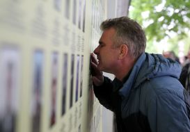Man near Memorial "The Wall of the People's Memory"