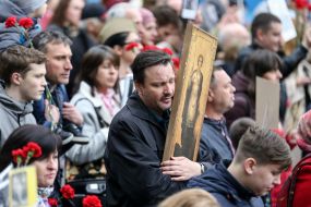 Участник акции "Бессмертный полк" держит икону