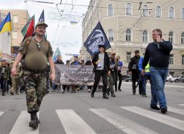 Marchers carry the flag of Ukraine