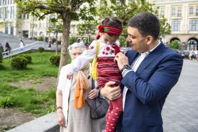 Vladimir Groisman holds a girl in embroidery shirt