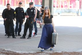 Girl in a Crimean Tatar suit with a suitcase