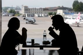 People are sitting at a table in a cafe. at the airport "Kiev"