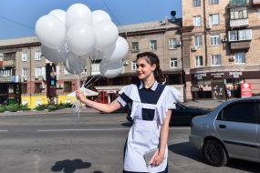 A graduate with balloons