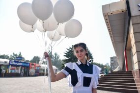 A graduate with balloons