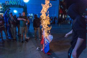 Participants of the action smoke the flag of Russia
