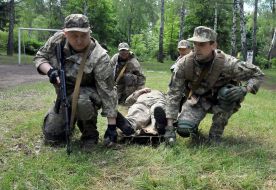 Fighters put on a stretcher conditionally wounded military
