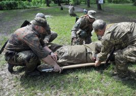 Fighters put on a stretcher conditionally wounded military
