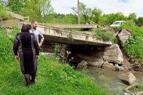 Andriy Ermak examines flood damaged bridge