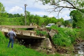 Andriy Ermak examines flood damaged bridge