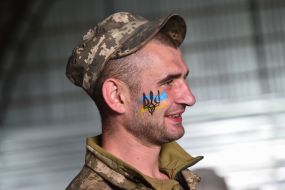 Flag and emblem painted on military face