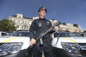 Сотрудник полиции возле служебных автомобилей