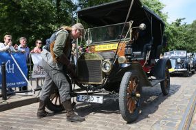 The driver inspects a retro car