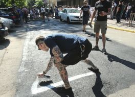 Activists of the initiative "Who ordered Katya Gandzjuk?" make an inscription on the asphalt