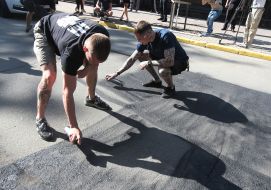 Activists of the initiative "Who ordered Katya Gandzjuk?" make an inscription on the asphalt