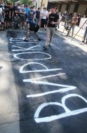 Activists of the initiative "Who ordered Katya Gandzjuk?" make an inscription on the asphalt