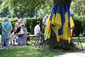 The flags of Ukraine are near the tree