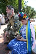 A serviceman and a girl in the Ukrainian national costume