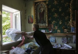The man collects things in a ruined house in Marinka
