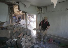 Rescuers of the DSSF scuttling down debris in a destroyed building in Marinka