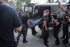 Special forces workers transport Dmitry Timchuk's body to the car