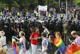 Law enforcers are bordered by members of the "Equality March"