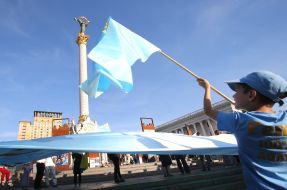 Rally participants hold the Crimean Tatar flag
