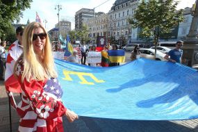 Participants of the procession with the Crimean Tatar flag