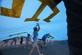 Rally participants hold the Crimean Tatar flag