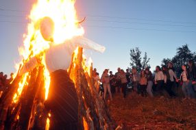 People lead dance around the fire