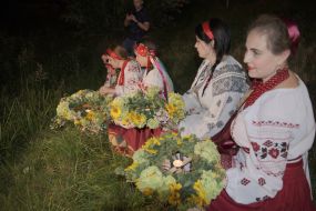 Girls carry wreaths to water