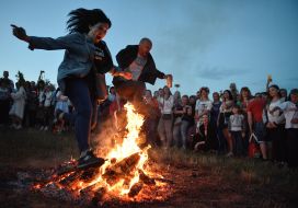 Young people jump over the fire