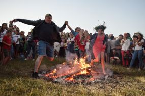 Young people jump over the fire