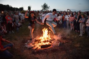 Young people jump over the fire