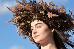 A girl in a wreath of wild flowers